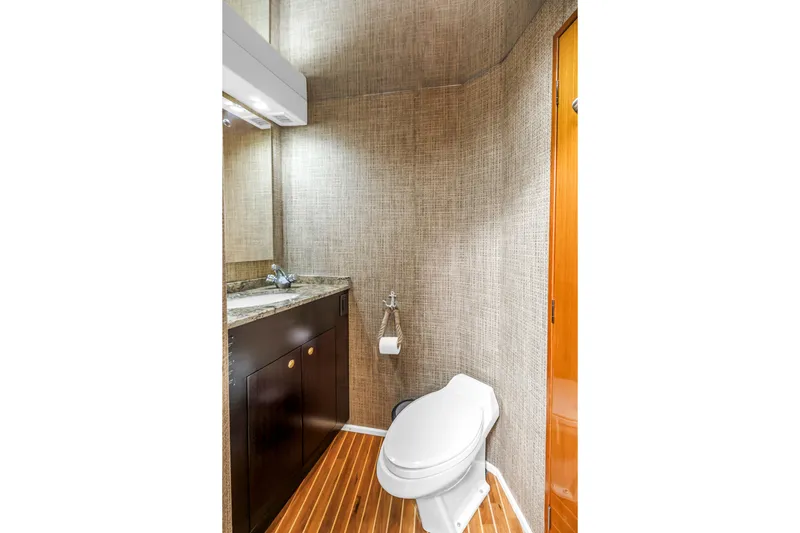 Slide: The Image of Luxurious bathroom in 1999 Viking 72 Enclosed Bridge yacht with modern fixtures and wood flooring. - 69
