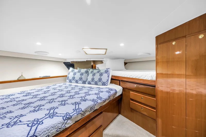Slide: The Image of Luxurious cabin interior of 1999 Viking 72 Enclosed Bridge yacht with twin beds. - 70