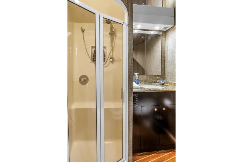 Slide: The Image of Bathroom interior of 1999 Viking 72 Enclosed Bridge yacht with shower and vanity. - 73