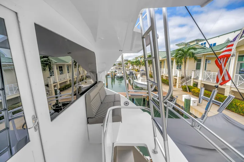 Slide: The Image of 1999 Viking 72 Enclosed Bridge yacht docked at marina, featuring sleek design and comfortable seating. - 74