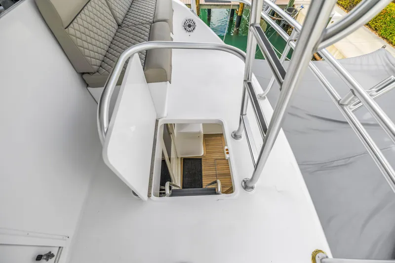 Slide: The Image of Stairway on 1999 Viking 72 Enclosed Bridge yacht, featuring cushioned seating and sleek railings. - 89