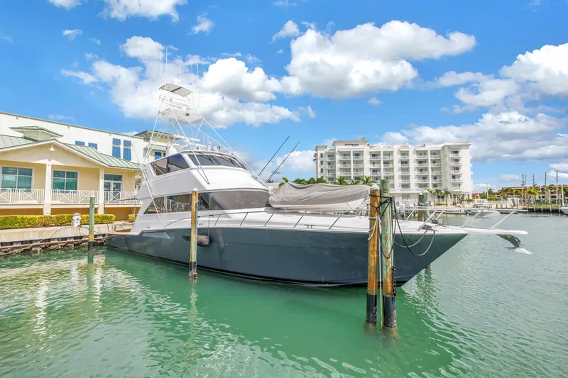 Slide: The Image of 1999 Viking 72 Enclosed Bridge yacht docked at marina under blue sky. - 9