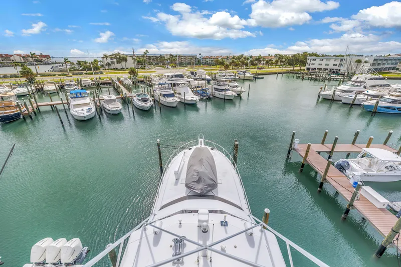 Slide: The Image of Aerial view of 1999 Viking 72 Enclosed Bridge yacht docked in a marina. - 92