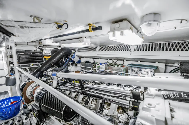 Slide: The Image of Engine room of 1999 Viking 72 Enclosed Bridge yacht, showcasing mechanical components. - 95