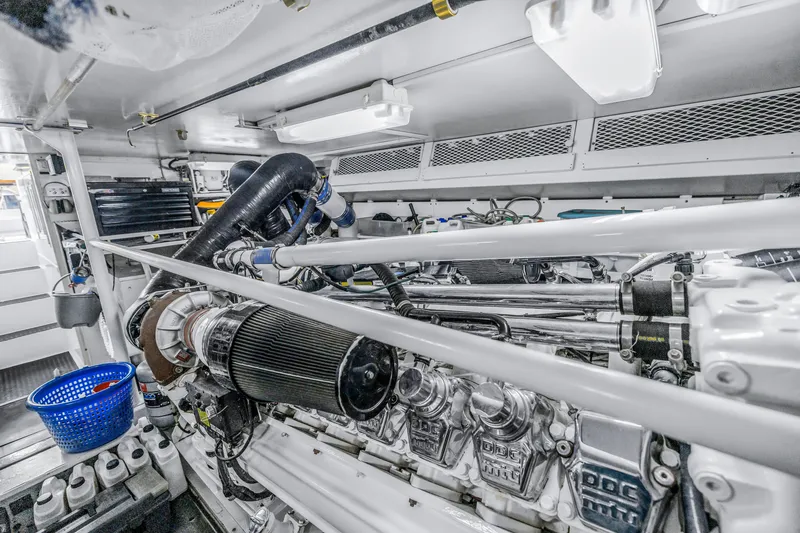 Slide: The Image of Engine room of a 1999 Viking 72 Enclosed Bridge yacht, showcasing mechanical components. - 97