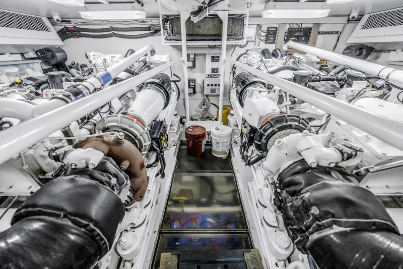 Slide: The Image of Engine room of 1999 Viking 72 Enclosed Bridge yacht, showcasing machinery and equipment. - 99