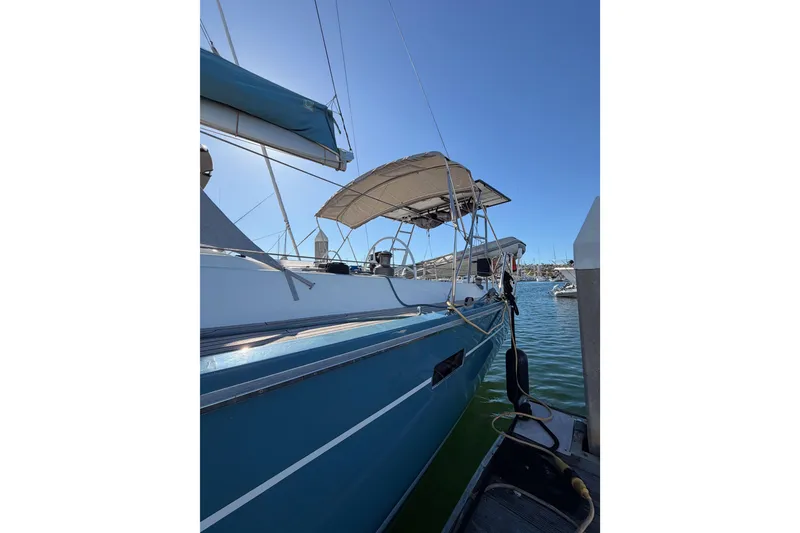 Slide: The Image of 2008 Hanse 540e sailboat docked in marina, blue hull, sunny day. - 11
