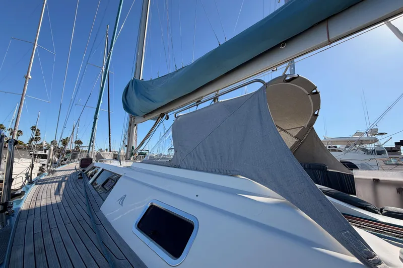 Slide: The Image of 2008 Hanse 540e sailboat deck with blue sail cover, docked in marina. - 13