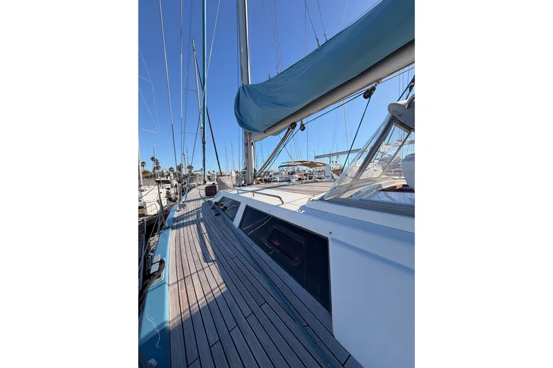 Slide: The Image of 2008 Hanse 540e sailboat deck with blue sail cover, docked in marina. - 14