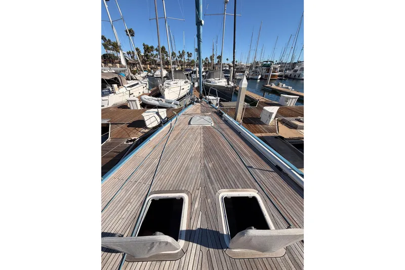 Slide: The Image of 2008 Hanse 540e yacht docked at marina, showcasing wooden deck and open hatches. - 15