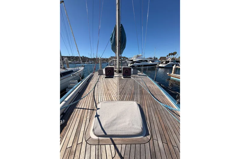 Slide: The Image of 2008 Hanse 540e yacht deck with wooden finish, docked in a marina under clear blue sky. - 21