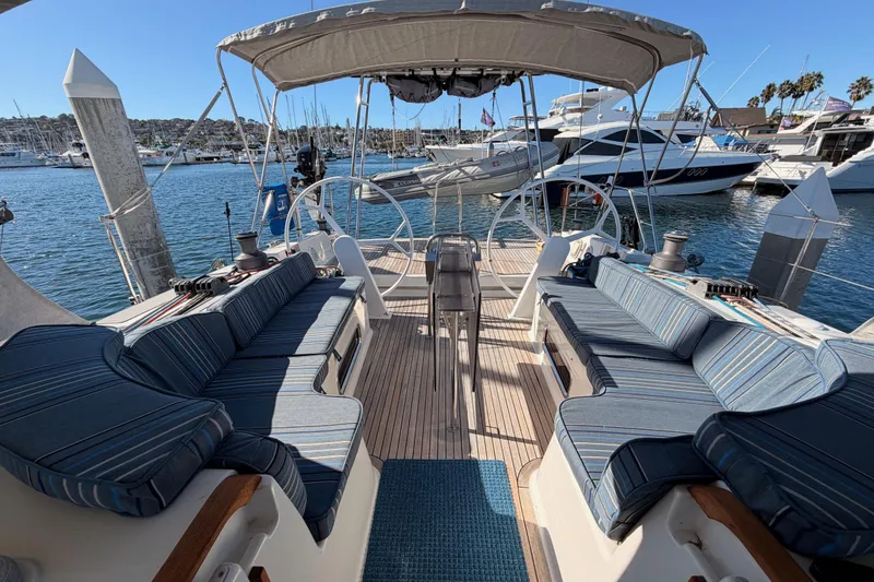 Slide: The Image of 2008 Hanse 540e yacht cockpit with striped cushions, docked in a marina. - 26