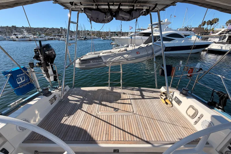Slide: The Image of 2008 Hanse 540e yacht deck with dinghy, docked in a marina with other boats. - 27