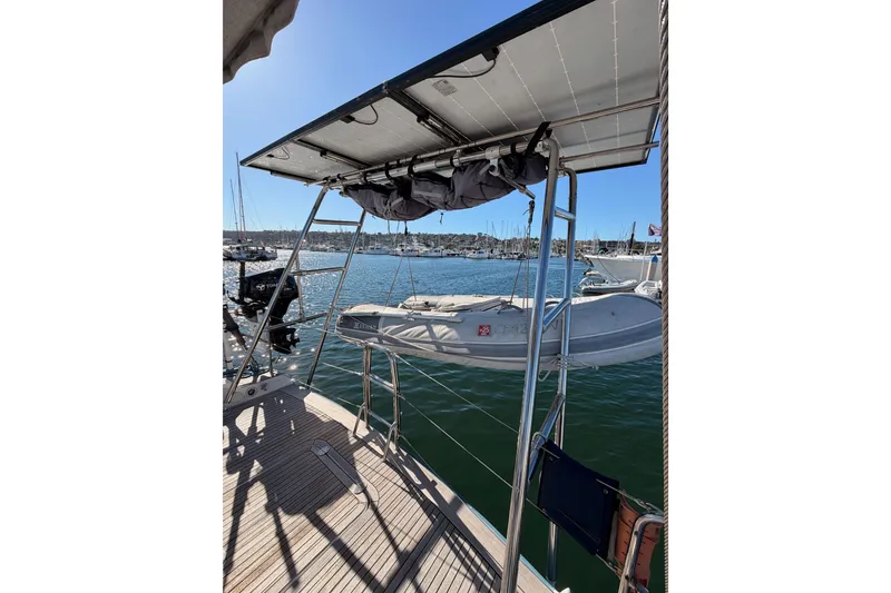Slide: The Image of 2008 Hanse 540e yacht with solar panels and dinghy on deck, docked in marina. - 28