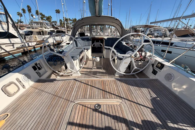 Slide: The Image of 2008 Hanse 540e yacht cockpit with dual steering wheels and wooden deck. - 34