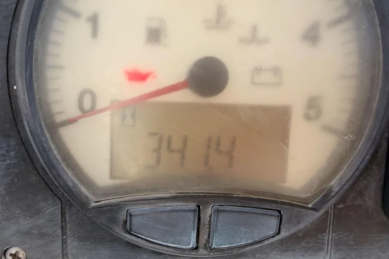 Slide: The Image of Close-up of a 2008 Hanse 540e gauge displaying 3414 hours with oil warning light. - 38