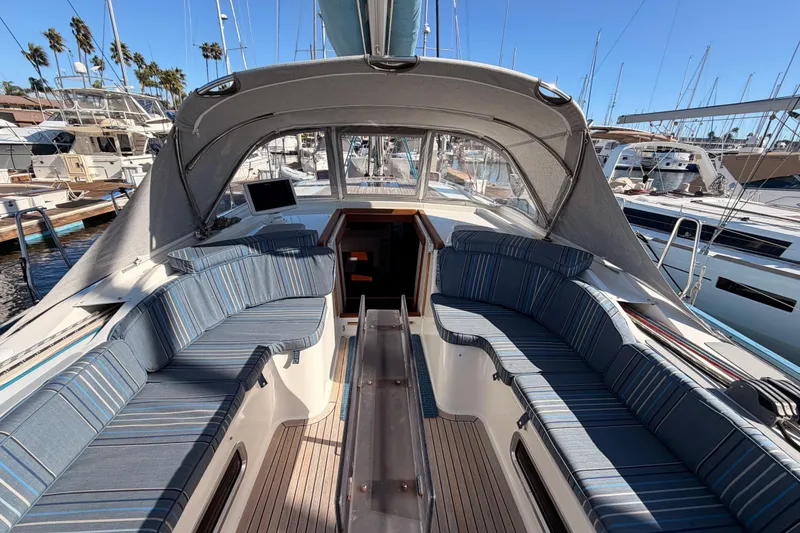 Slide: The Image of 2008 Hanse 540e yacht cockpit with striped seating, docked at marina under clear blue sky. - 44