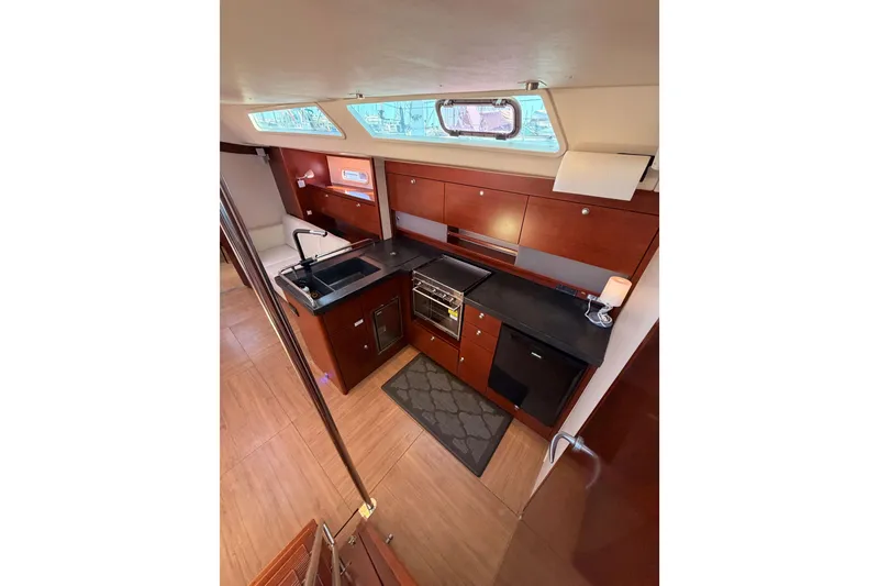 Slide: The Image of 2008 Hanse 540e yacht interior kitchen with modern wood cabinetry and appliances. - 49