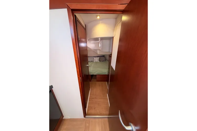 Slide: The Image of Interior view of 2008 Hanse 540e yacht cabin with wooden door and cozy bed. - 62