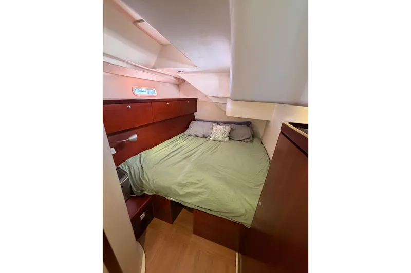 Slide: The Image of Cozy cabin interior of 2008 Hanse 540e yacht with bed and wooden furnishings. - 63
