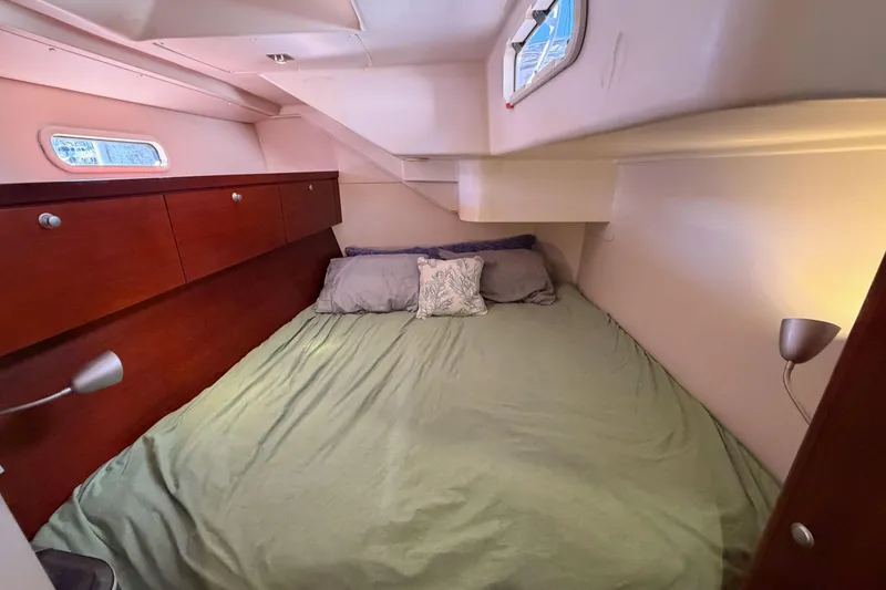 Slide: The Image of Cozy cabin interior of 2008 Hanse 540e yacht with bed and wooden storage. - 64