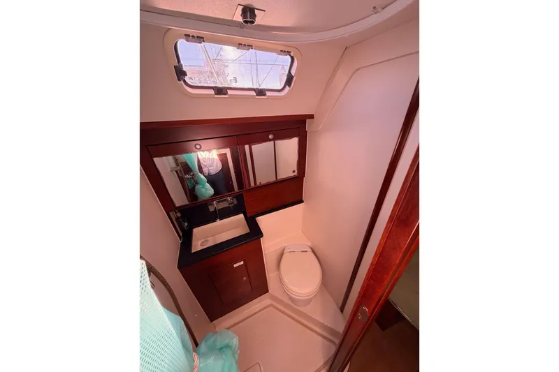 Slide: The Image of Luxurious bathroom in 2008 Hanse 540e yacht with modern fixtures and wooden accents. - 67