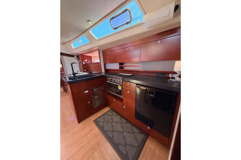 Slide: The Image of Luxurious 2008 Hanse 540e yacht kitchen with modern appliances and elegant wood cabinetry. - 69