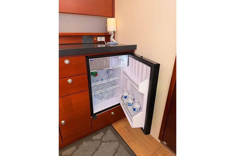 Slide: The Image of Open mini fridge in 2008 Hanse 540e yacht, stocked with water bottles and drinks. - 70