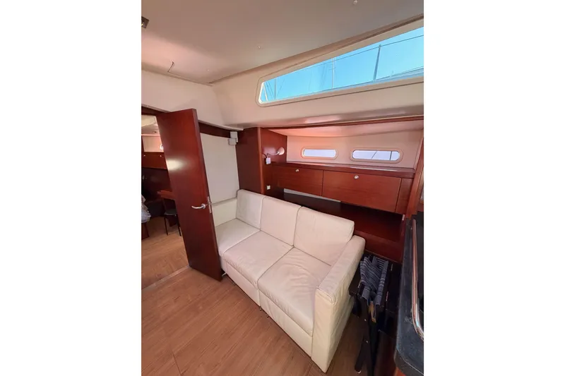 Slide: The Image of Interior of 2008 Hanse 540e yacht with white sofa and wooden cabinetry. - 77