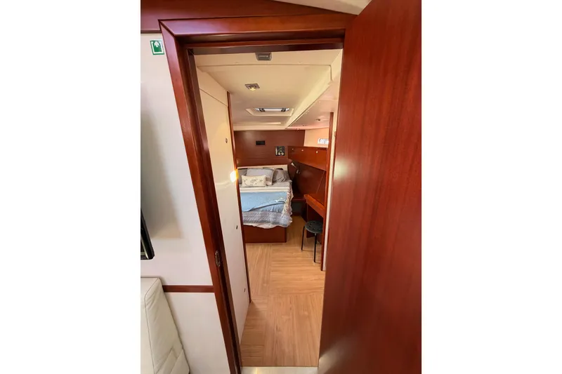 Slide: The Image of Interior view of 2008 Hanse 540e yacht cabin with wooden furnishings and cozy bed. - 79