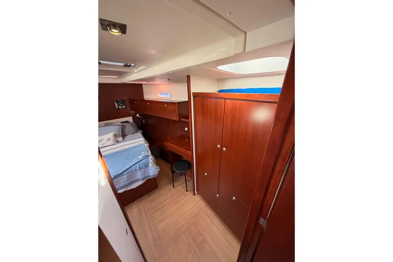 Slide: The Image of Interior of 2008 Hanse 540e yacht cabin with wooden furnishings and cozy bed. - 80