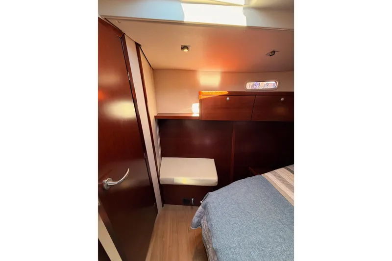 Slide: The Image of Interior of 2008 Hanse 540e yacht cabin with wooden finish and cozy bed. - 83