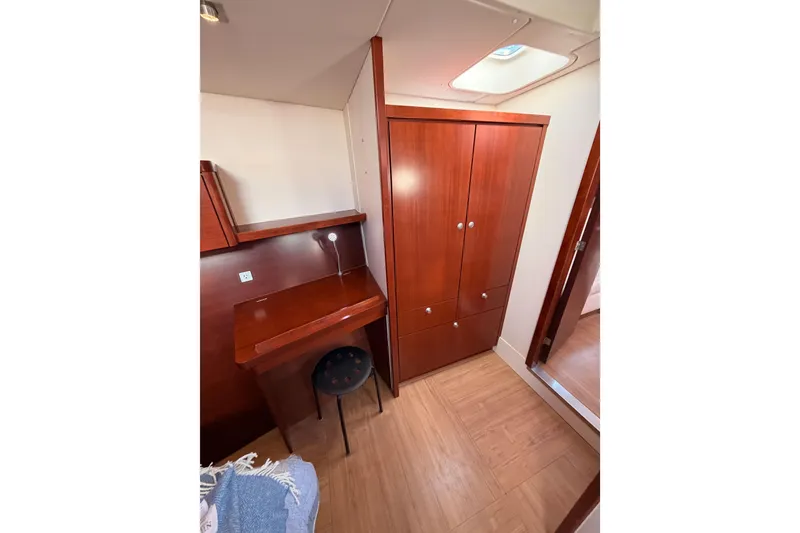 Slide: The Image of Interior of 2008 Hanse 540e yacht with wooden cabinetry and desk area. - 87