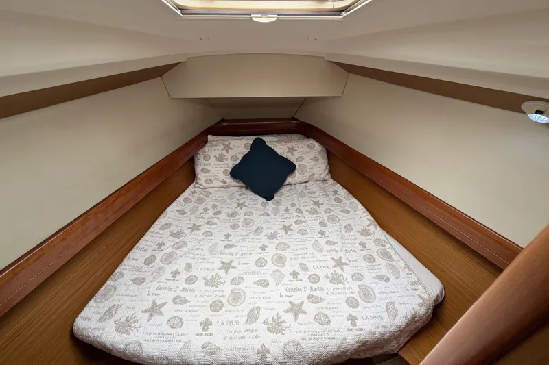 Slide: The Image of 2007 Jeanneau Sun Odyssey 42 DS cabin with cozy bed and nautical-themed bedding. - 49