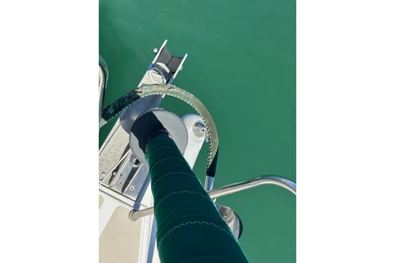 Slide: The Image of Bow of 1996 J Boats J/120 sailboat with green water backdrop. - 15