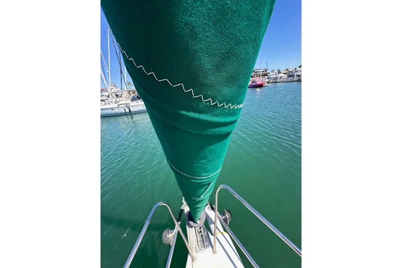 Slide: The Image of Close-up of a green sail on a 1996 J Boats J/120 in a marina. - 17