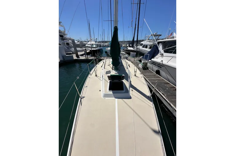 Slide: The Image of 1996 J Boats J/120 sailboat docked at marina under clear blue sky. - 18