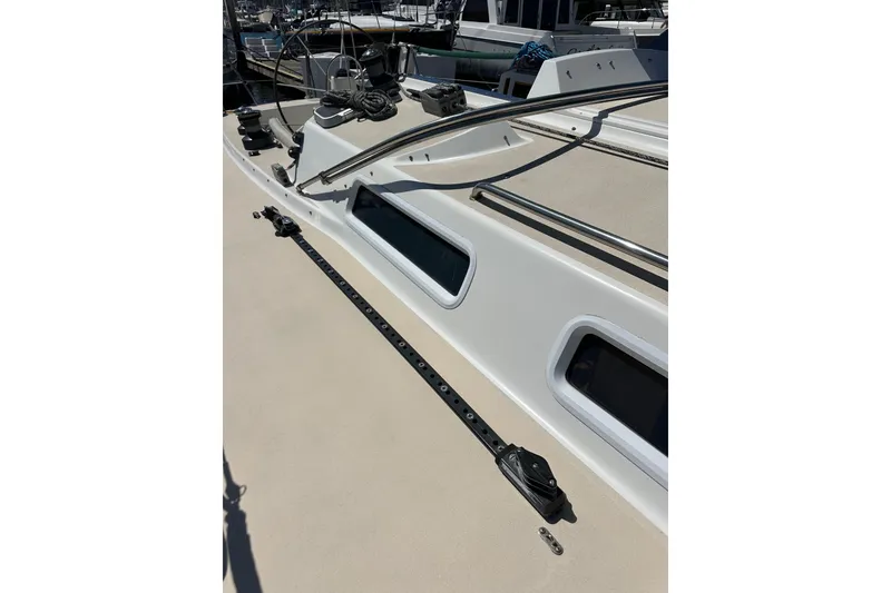Slide: The Image of 1996 J Boats J/120 deck with winches and rigging, docked at marina. - 21