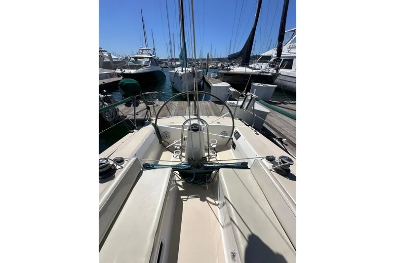 Slide: The Image of 1996 J Boats J/120 sailboat cockpit view in marina, surrounded by other boats. - 23