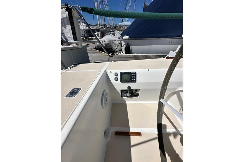 Slide: The Image of 1996 J Boats J/120 cockpit with steering wheel and control panel at marina. - 27