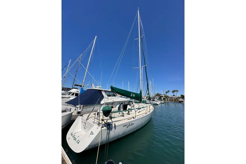 Slide: The Image of 1996 J Boats J/120 sailboat docked in marina under clear blue sky. - 3