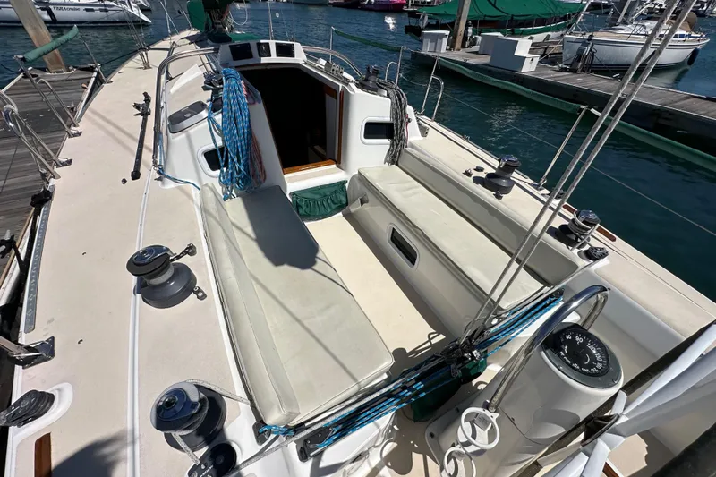 Slide: The Image of 1996 J Boats J/120 sailboat cockpit with winches and ropes, docked at marina. - 30