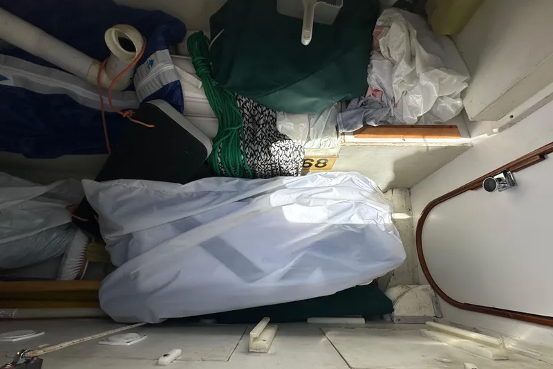 Slide: The Image of Interior storage area of a 1996 J Boats J/120 sailboat with various equipment. - 32