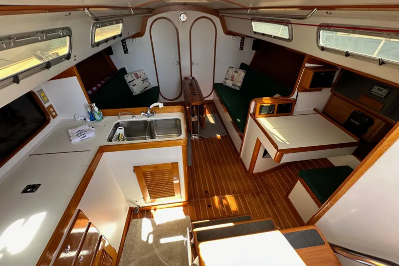 Slide: The Image of Interior of 1996 J Boats J/120 sailboat with wood accents and compact kitchen area. - 35