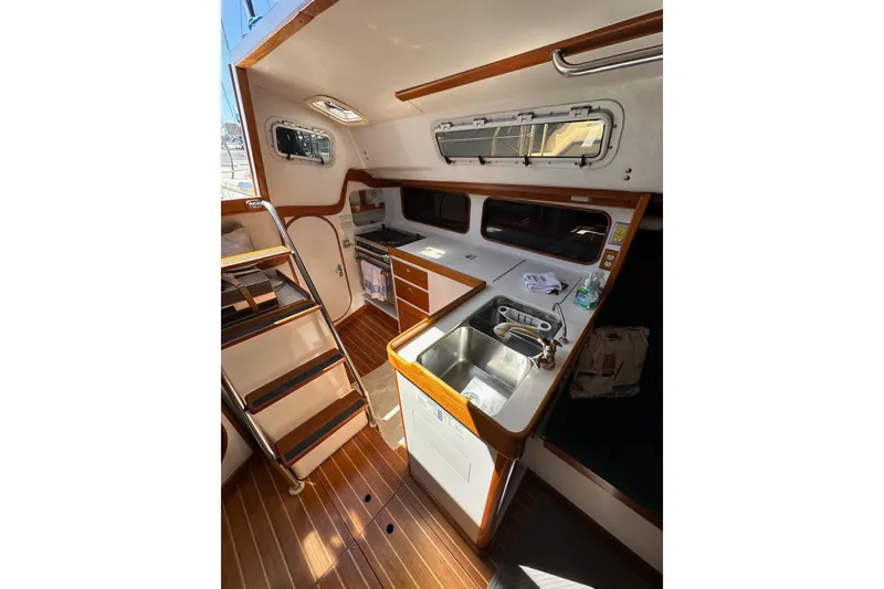 Slide: The Image of Interior of 1996 J Boats J/120 sailboat with kitchen and wooden flooring. - 37