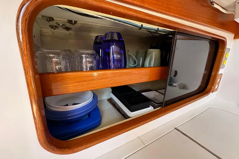 Slide: The Image of Cabinet interior of 1996 J Boats J/120 with glasses and mugs neatly arranged. - 41