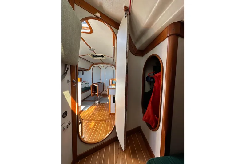 Slide: The Image of Interior of 1996 J Boats J/120 sailboat, featuring wood accents and cozy cabin space. - 48