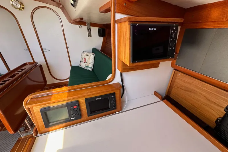 Slide: The Image of Interior of 1996 J Boats J/120 yacht with wood finish and navigation equipment. - 50