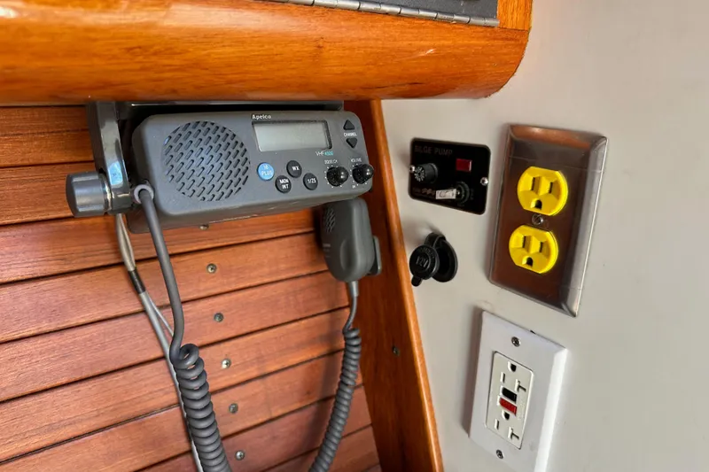 Slide: The Image of VHF radio and electrical outlets on 1996 J Boats J/120 yacht interior. - 54