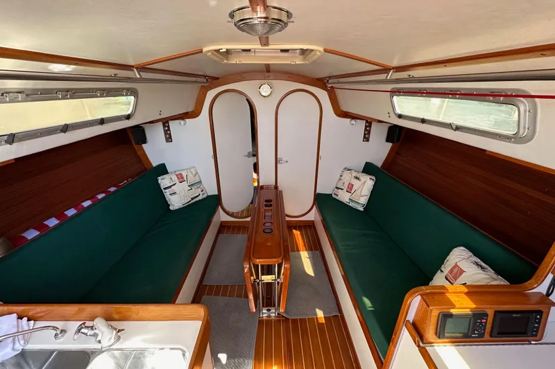 Slide: The Image of Interior of 1996 J Boats J/120 sailboat with green seating and wood accents. - 57